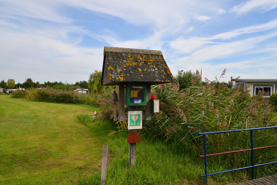 AED by the bridge for safety at naturist site De Brongaard