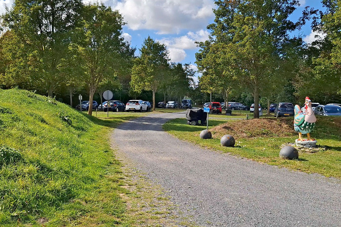 Spacious parking lot at entrance of naturist site De Brongaard